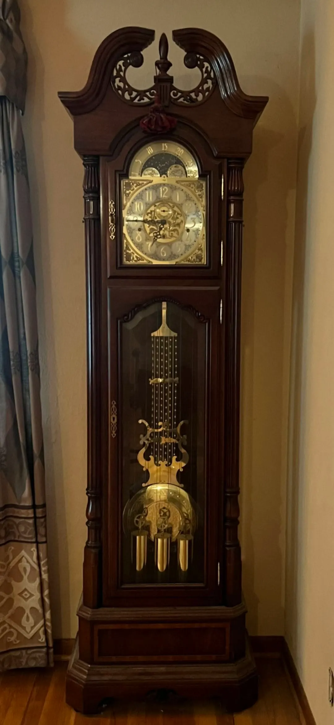 Restored mahogany grandfather clock with broken-pediment carved crown and lyre pendulum