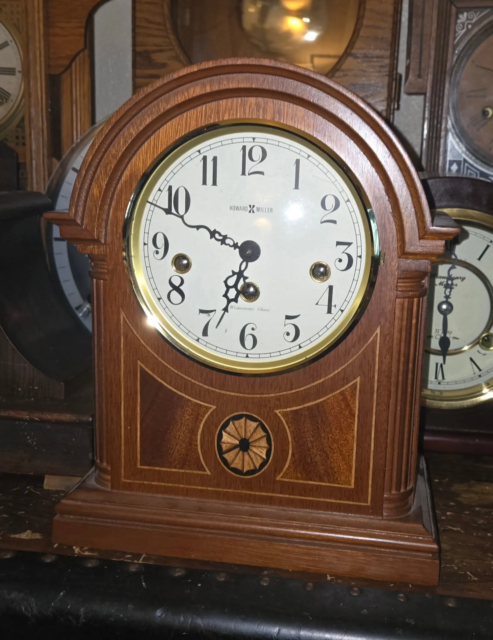 Howard Miller barrel-top mahogany mantel clock with inlaid rosette detail, on the workbench